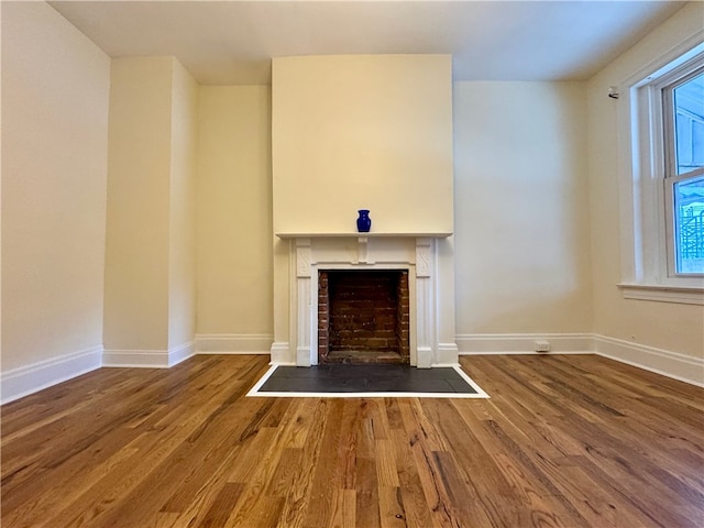 3730 Liberty Ave, Lawrenceville, PA 15201 - unfurnished living room featuring a fireplace with flush hearth, baseboards, and wood finished floors