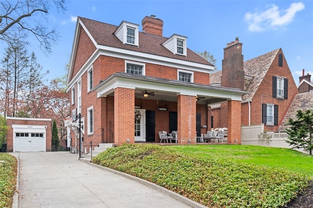 6649 Kinsman Rd, Squirrel Hill, PA 15217 - view of front of home with an outbuilding, a ceiling fan, brick siding, a chimney, and concrete driveway