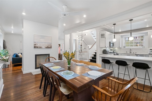 6649 Kinsman Rd, Squirrel Hill, PA 15217 - dining space with dark wood-style flooring, ornamental molding, recessed lighting, a fireplace, and stairway