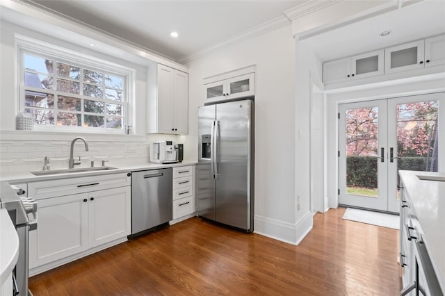 6649 Kinsman Rd, Squirrel Hill, PA 15217 - kitchen with ornamental molding, appliances with stainless steel finishes, a sink, baseboards, and dark wood-style floors