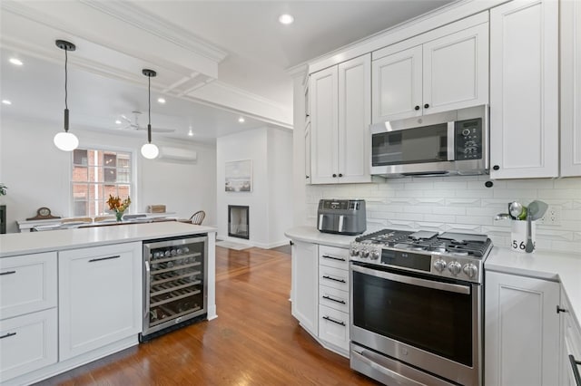 6649 Kinsman Rd, Squirrel Hill, PA 15217 - kitchen with wine cooler, appliances with stainless steel finishes, light countertops, and backsplash