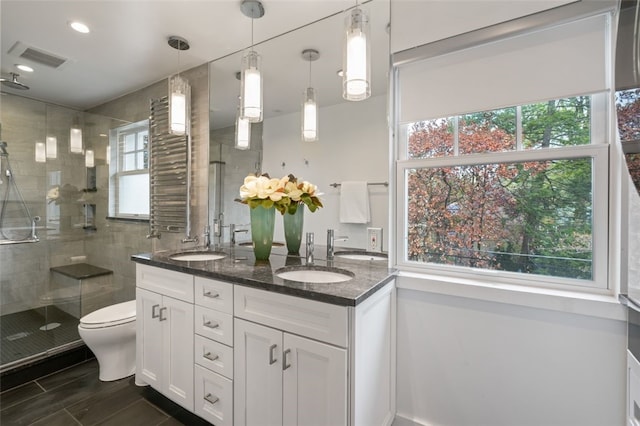 6649 Kinsman Rd, Squirrel Hill, PA 15217 - full bath with visible vents, toilet, a sink, a stall shower, and double vanity