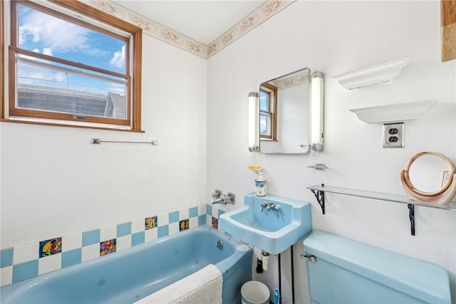 bathroom featuring toilet and a bath