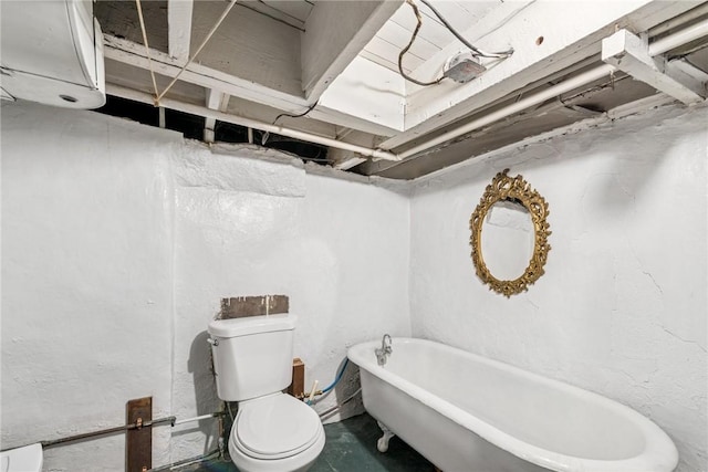 full bathroom with toilet and a freestanding tub