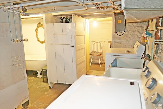clothes washing area with laundry area, electric panel, and washer / dryer