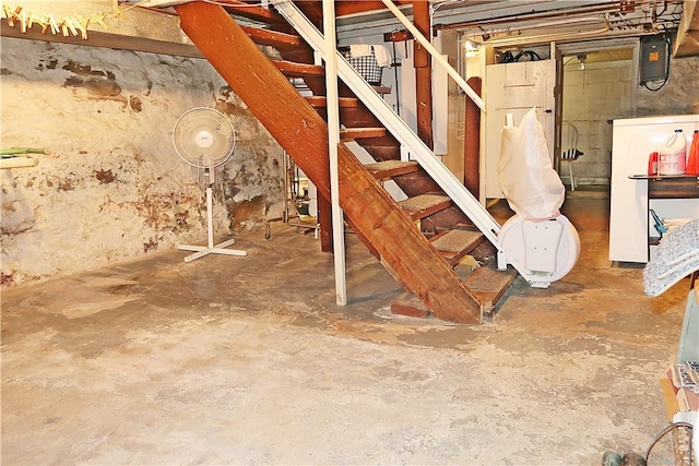 unfinished basement featuring stairs