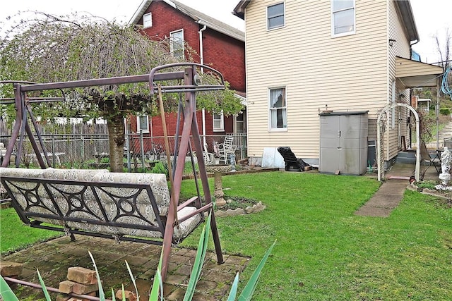 exterior space featuring fence and a lawn