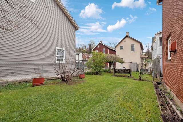 view of yard featuring a residential view and fence