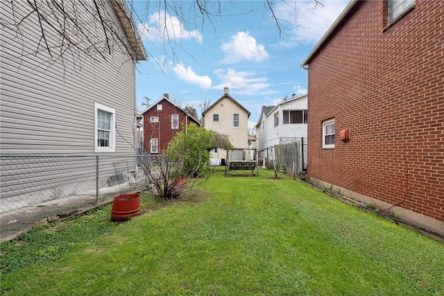 view of yard featuring a residential view and fence