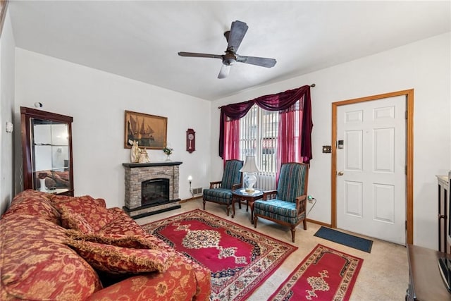 living area featuring light carpet, visible vents, a stone fireplace, and ceiling fan