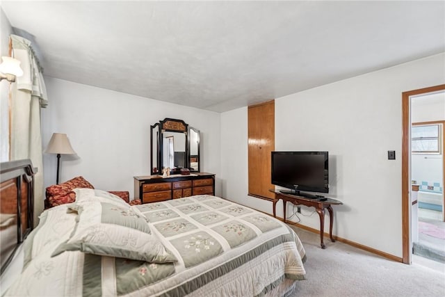 bedroom with baseboards and carpet