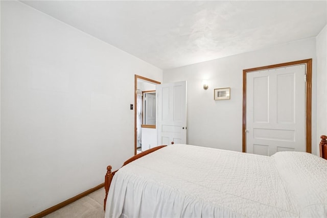 bedroom with baseboards and light colored carpet