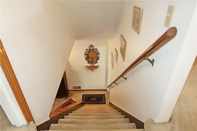 staircase featuring carpet flooring and visible vents