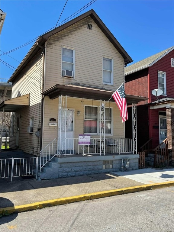 traditional home featuring cooling unit and covered porch