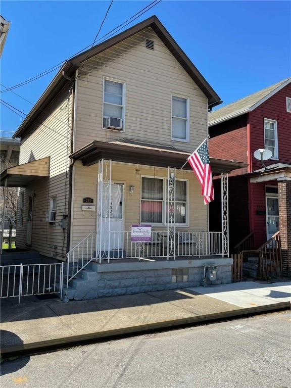 view of front facade with covered porch and cooling unit