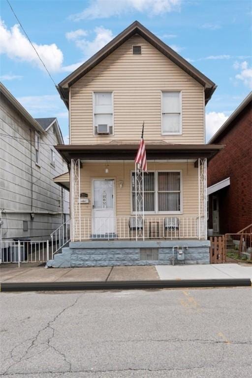 view of front of house featuring a porch and cooling unit