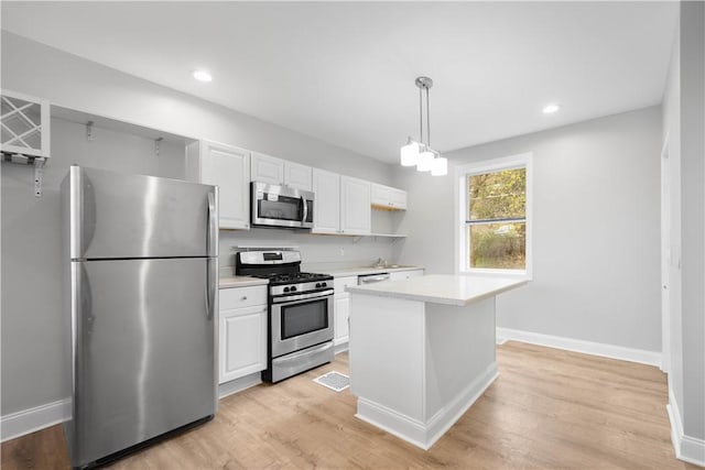 kitchen featuring light wood finished floors, light countertops, white cabinetry, and stainless steel appliances