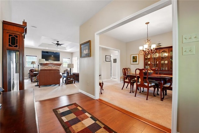 105 Hillcrest Rd, Penn Twp But, PA 16053 - carpeted dining space with wood finished floors, a tray ceiling, a chandelier, and a ceiling fan