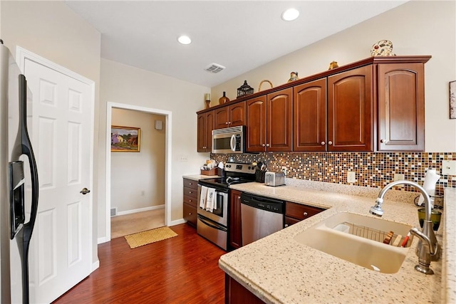 105 Hillcrest Rd, Penn Twp But, PA 16053 - kitchen with stainless steel appliances, a sink, backsplash, dark wood finished floors, and light stone countertops