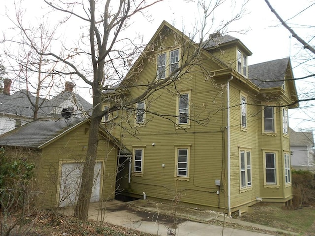 198 W Pearl St, City Of But Nw, PA 16001 - rear view of house featuring a garage and roof with shingles
