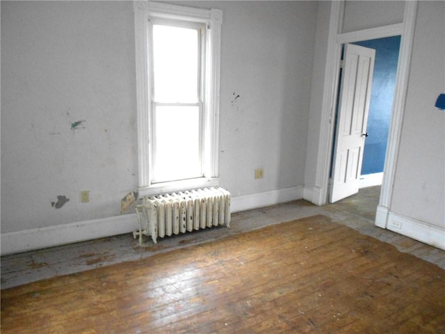 198 W Pearl St, City Of But Nw, PA 16001 - spare room with baseboards, wood finished floors, radiator, and a healthy amount of sunlight