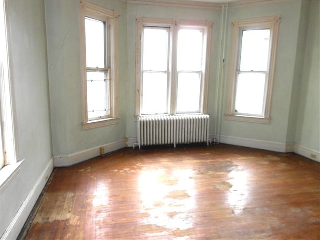 198 W Pearl St, City Of But Nw, PA 16001 - spare room with radiator heating unit, wood finished floors, and baseboards