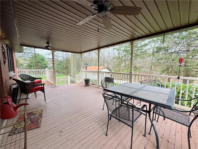 deck featuring ceiling fan and outdoor dining area