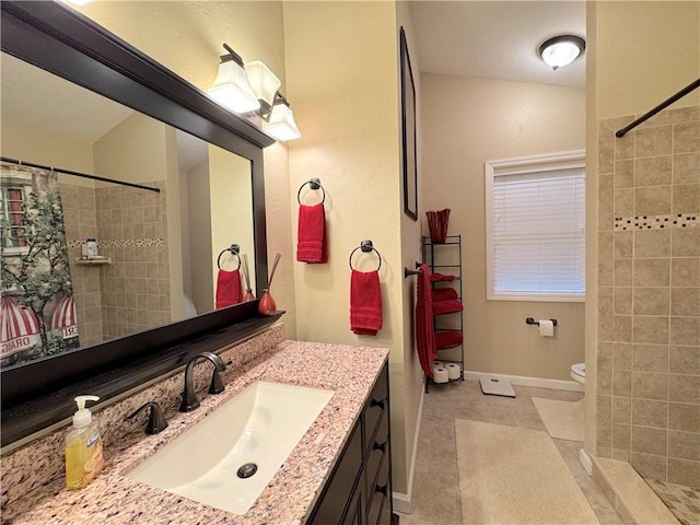 bathroom featuring toilet, curtained shower, vanity, and tile patterned flooring