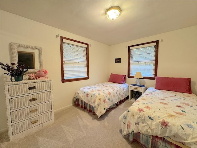 carpeted bedroom featuring baseboards