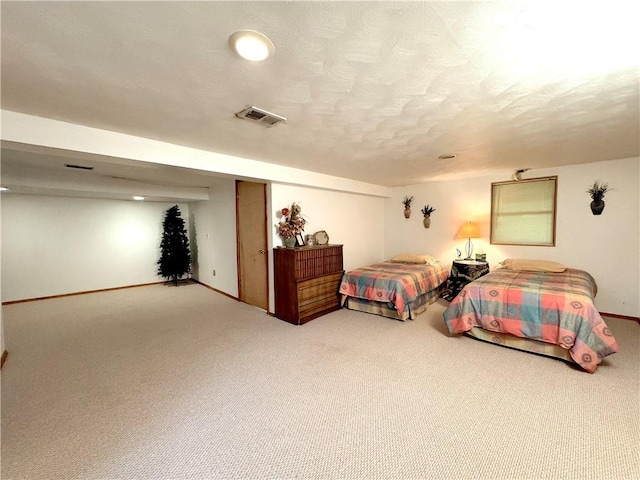 bedroom featuring a closet, baseboards, carpet flooring, a textured ceiling, and visible vents