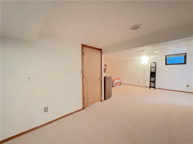 interior space with baseboards and carpet
