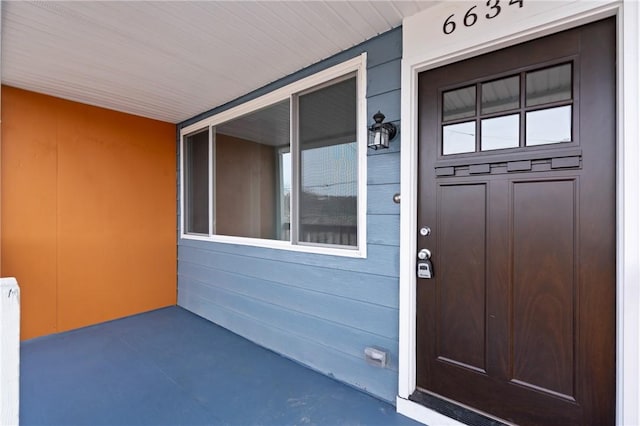 entrance to property with a porch and radiator
