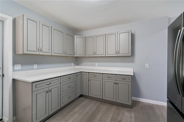 interior space with light wood-style flooring and baseboards