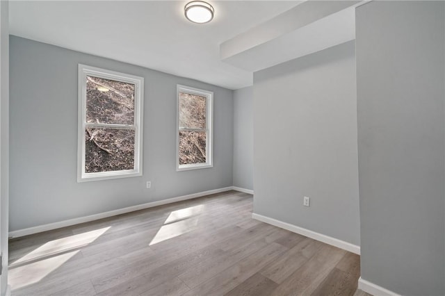 unfurnished room featuring wood finished floors and baseboards