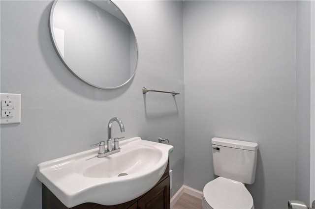 half bathroom featuring toilet and vanity