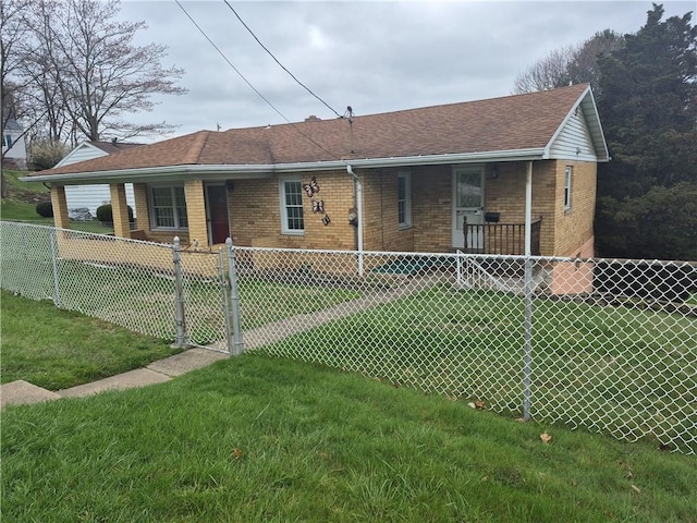 back of property with brick siding, fence, a shingled roof, and a yard