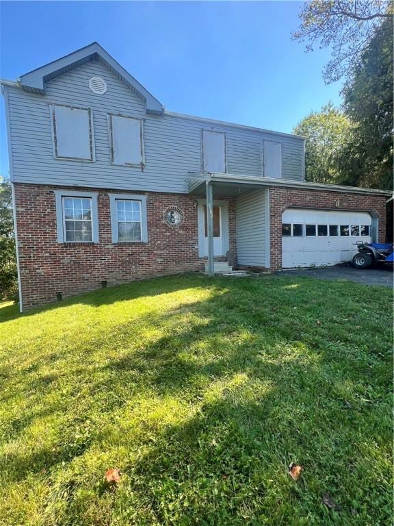 traditional home featuring brick siding, driveway, an attached garage, and a front lawn