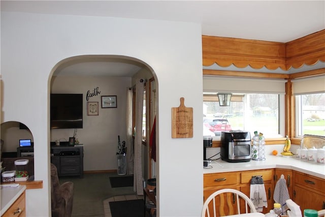192 S Franklin, St, PA 16314 - kitchen with brown cabinets, light countertops, arched walkways, and tile patterned flooring