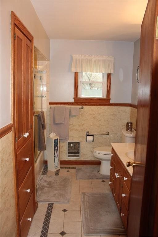 192 S Franklin, St, PA 16314 - full bathroom featuring vanity, tile patterned flooring, toilet, enclosed tub / shower combo, and heating unit