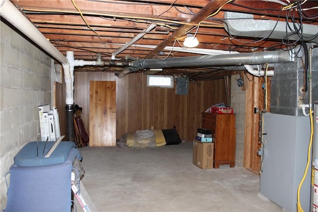192 S Franklin, St, PA 16314 - below grade area featuring wooden walls, heating unit, and concrete block wall