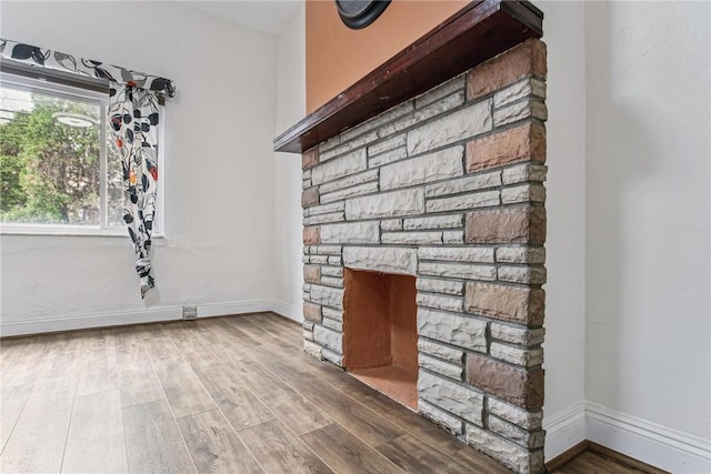 4106 Garden Way, Lawrenceville, PA 15201 - unfurnished living room featuring baseboards, wood finished floors, and a fireplace