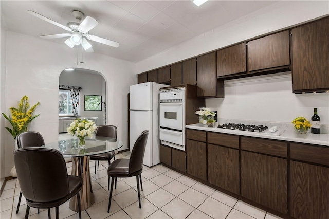 4106 Garden Way, Lawrenceville, PA 15201 - kitchen with light countertops, a warming drawer, white appliances, and dark brown cabinetry
