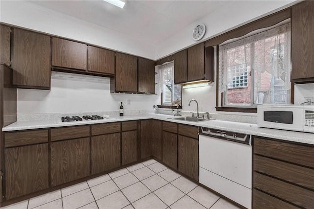 4106 Garden Way, Lawrenceville, PA 15201 - kitchen with a sink, light countertops, white appliances, dark brown cabinetry, and light tile patterned flooring