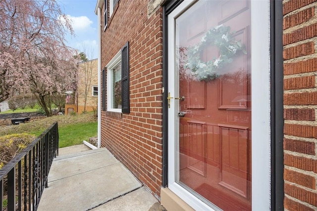 doorway to property with brick siding