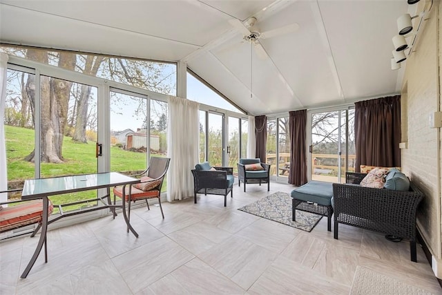 sunroom featuring ceiling fan and vaulted ceiling