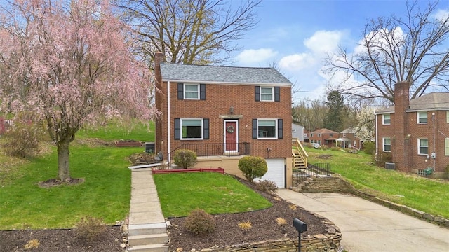 view of front of house featuring an attached garage, concrete driveway, a front lawn, and brick siding