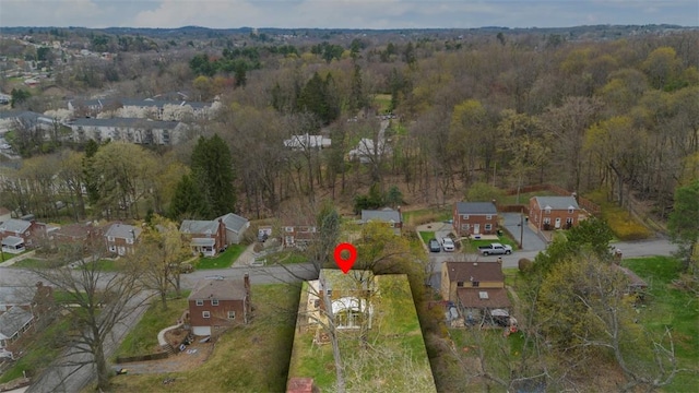 aerial view featuring a forest view and a residential view