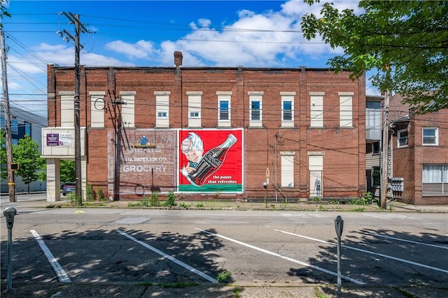 view of building exterior featuring uncovered parking