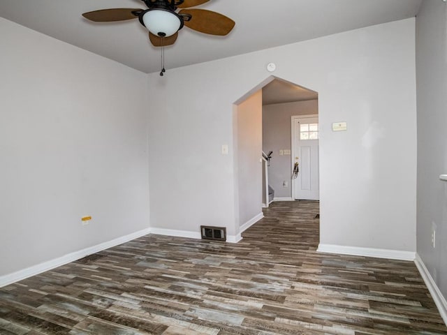 unfurnished room with visible vents, baseboards, wood finished floors, and ceiling fan
