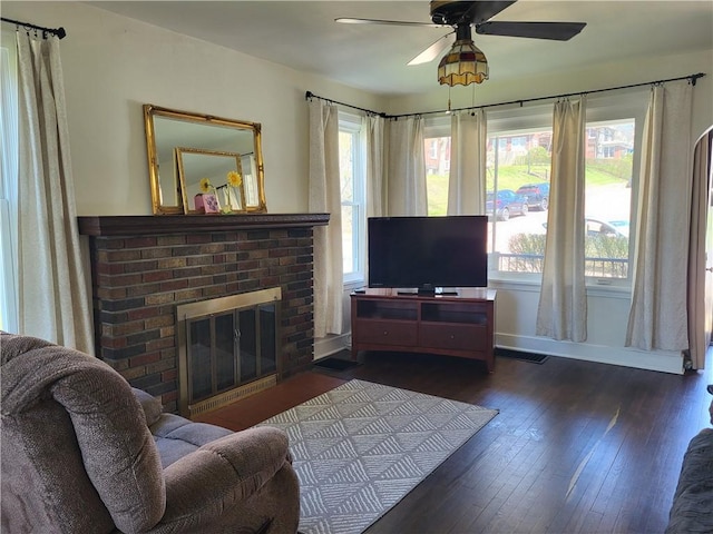 211 Oak St, City Of But Ne, PA 16001 - living area featuring baseboards, a brick fireplace, visible vents, ceiling fan, and wood-type flooring